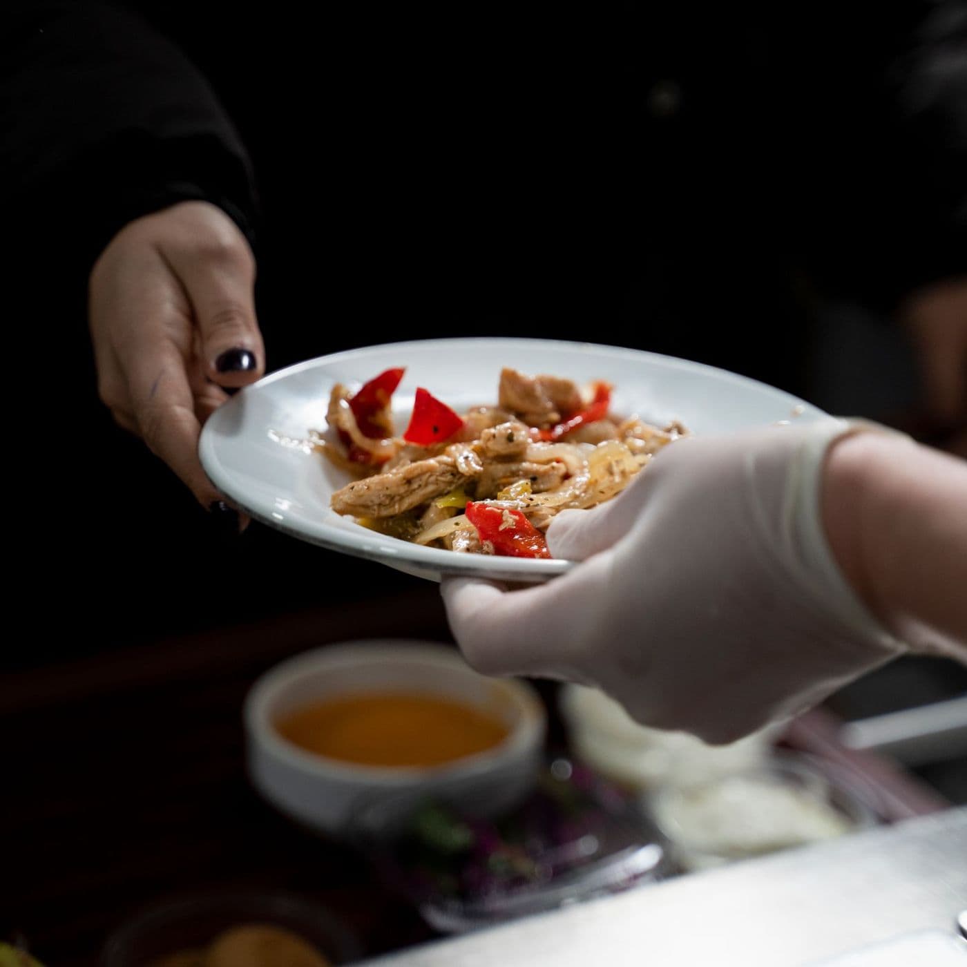 A plate being handed over at the kitchen pass