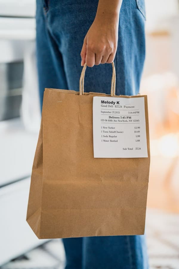 A takeaway bag with its printed order ticket